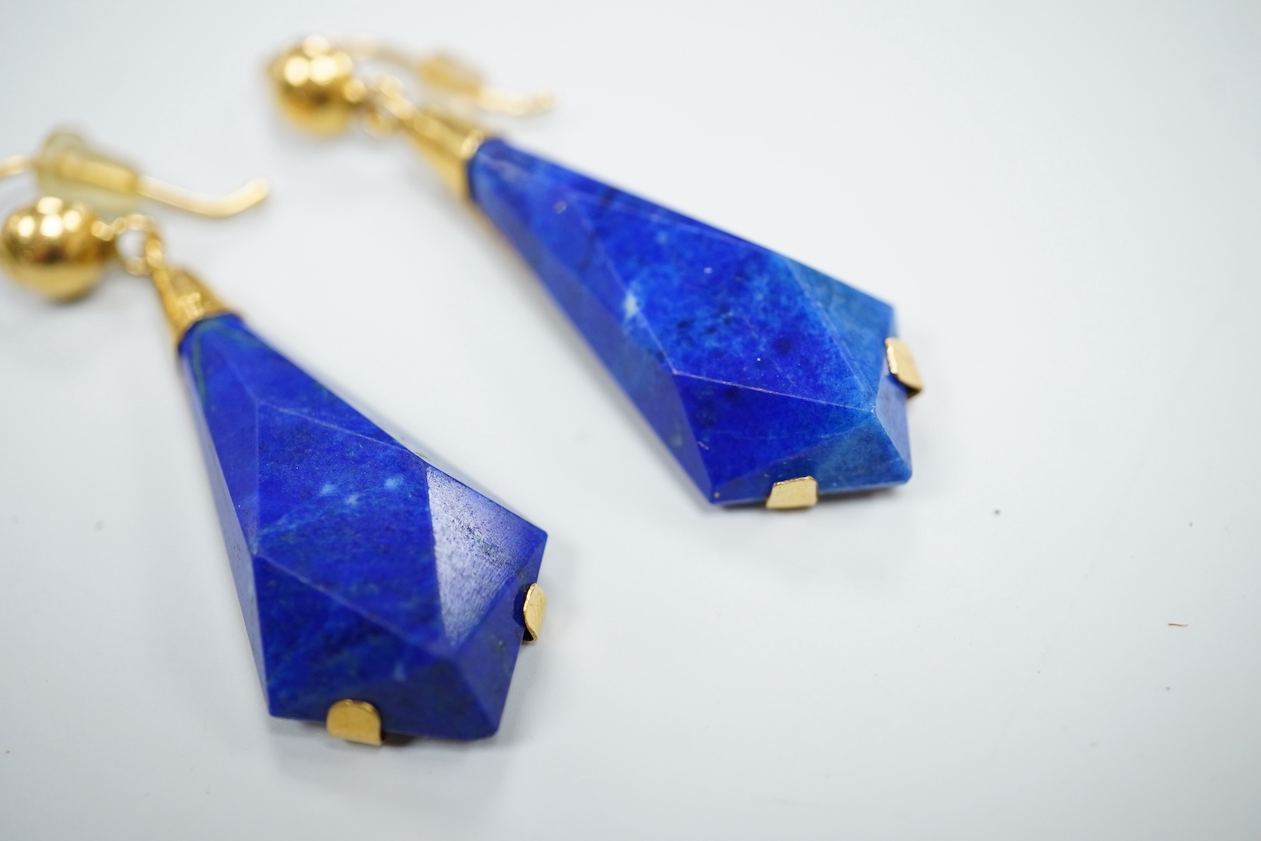 A pair of yellow metal and angular cut lapis lazuli set drop earrings, overall 42mm, gross weight 8.6 grams.